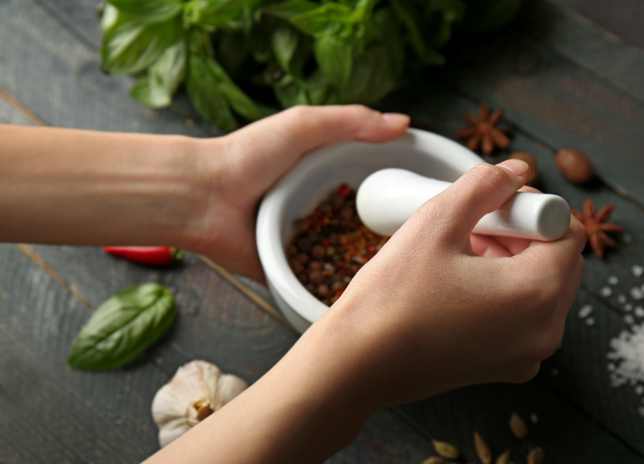 Hands Grinding Spices in Mortar